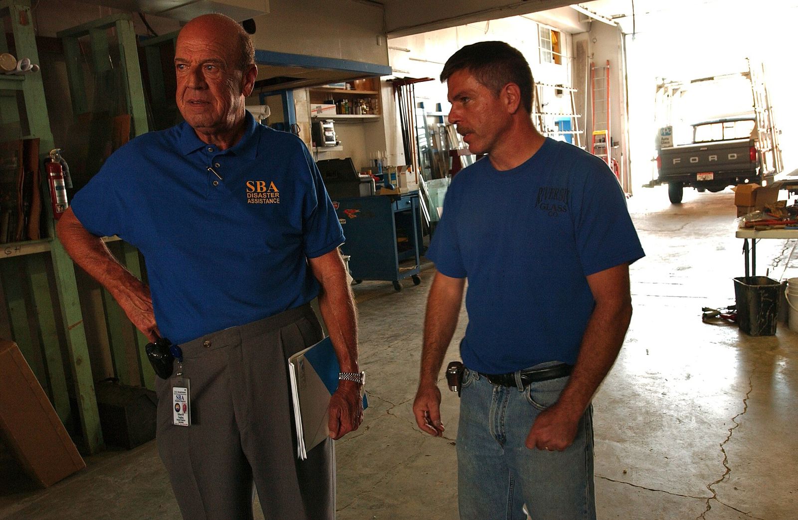 An SBA advisor meeting with local business owners outside their shop